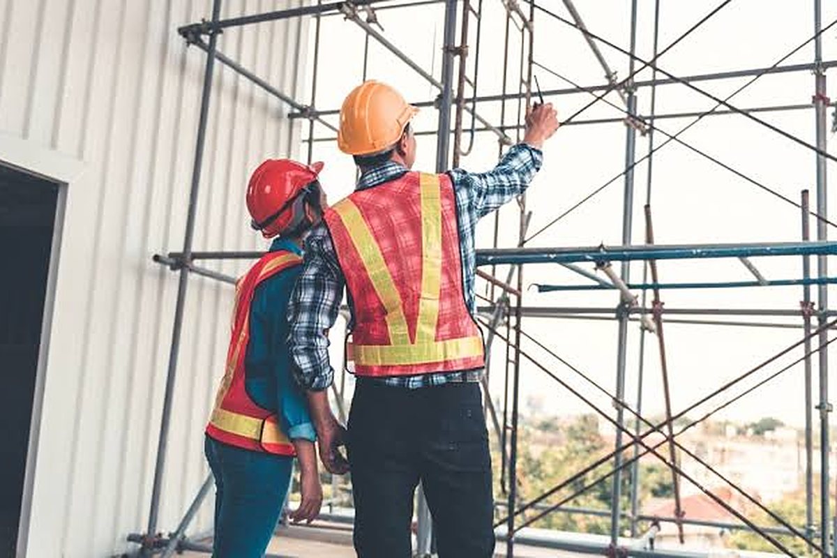 Site engineers inspecting an erected scaffold against the design load class